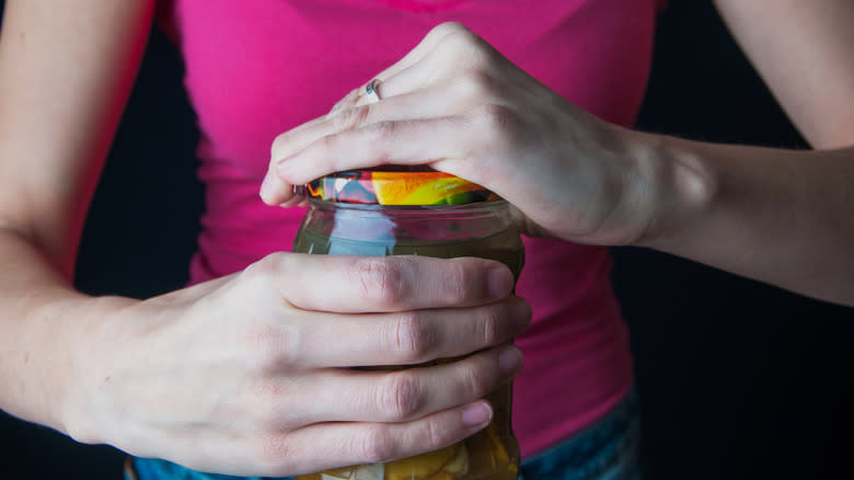 woman opening jar 