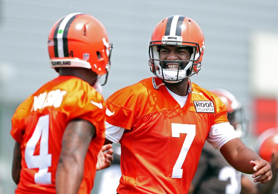 Cleveland Browns quarterback Jacoby Brissett, facing, shares a laugh with Deshaun Watson during the NFL football team's football training camp in Berea on Monday.