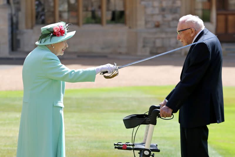 FILE PHOTO: Fundraising UK veteran Captain Tom receives knighthood from Britain's Queen Elizabeth at Windsor Castle