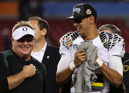 Chip Kelly and Marcus Mariota after Oregon's win over Kansas State in the Tostitos Fiesta Bowl in 2013.  (Getty Images)