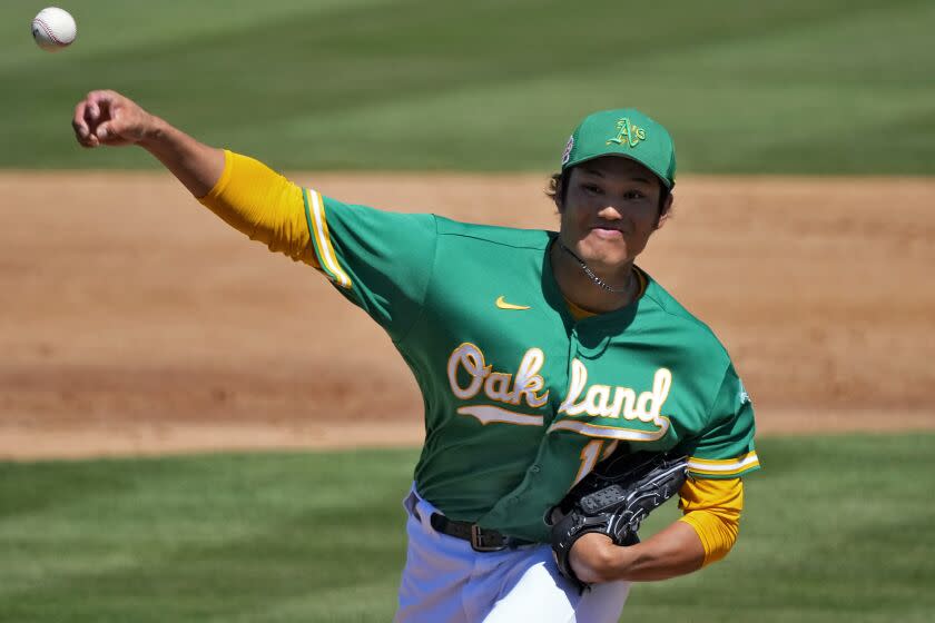 Oakland Athletics starting pitcher Shintaro Fujinami (11), of Japan, throws against the Milwaukee Brewers.