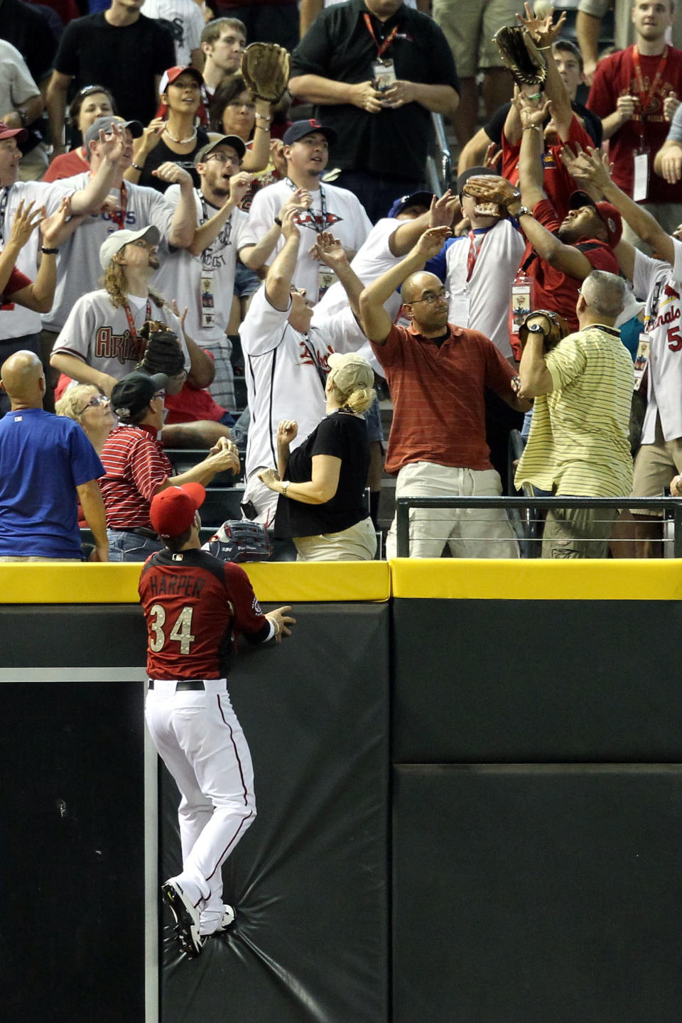 PHOENIX, AZ - JULY 10: U.S. Futures All-Star Bryce Harper #34 of the Washington Nationals watches a home run by World Future's All-Star Alfredo Silverio #27 of the Los Angeles Dodgers in the sixth inning of the 2011 XM All-Star Futures Game at Chase Field on July 10, 2011 in Phoenix, Arizona. (Photo by Christian Petersen/Getty Images)