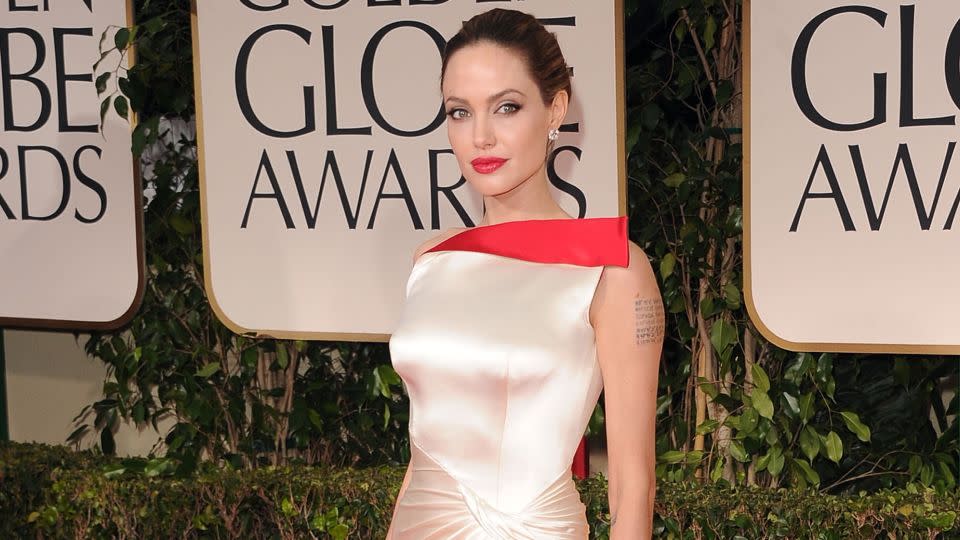 The month before, Jolie had attended the Golden Globe Awards in a white satin number, also by Versace. - Jason Merritt/Getty Images