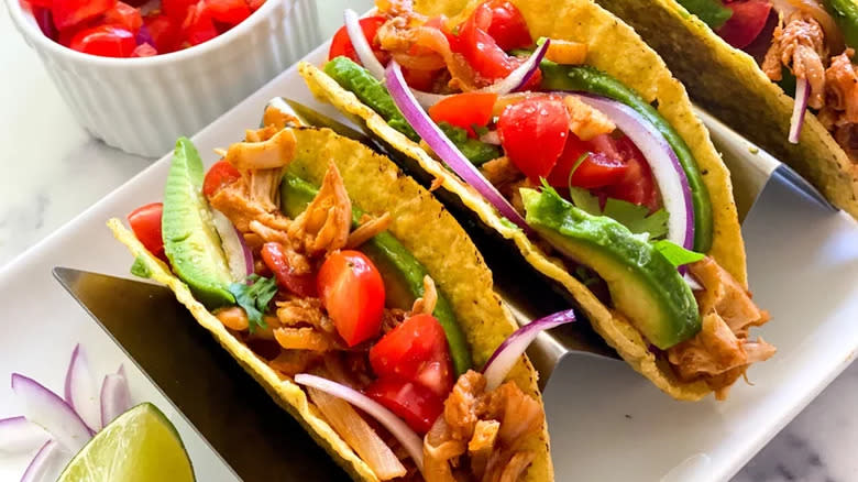 Tacos with avocado and cherry tomatoes in stand