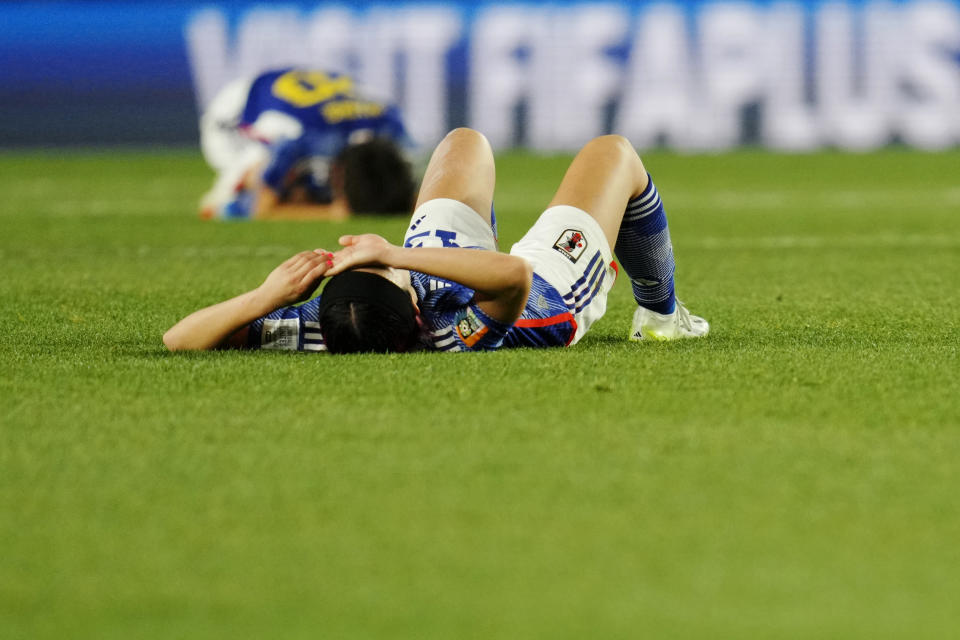 Japan's Jun Endo and Maika Hamano, background, react at the end of the Women's World Cup quarterfinal soccer match between Japan and Sweden at Eden Park in Auckland, New Zealand, Friday, Aug. 11, 2023. Sweden won 2-1. (AP Photo/Abbie Parr)