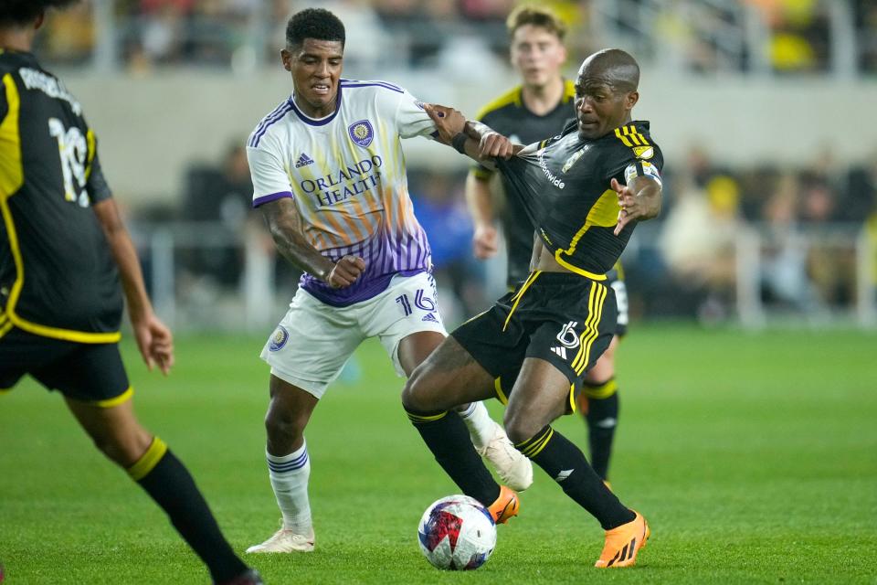 Orlando midfielder Wilder Cartagena (16) battles Crew midfielder Darlington Nagbe on May 13.