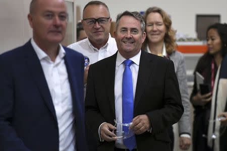 International Trade Secretary Liam Fox (C) walks Managing Director Tony Birmingham (L), Sales Director Mick Bonney (2nd L), and Marion Sudbury from the Department of International Trade, during a visit to EDM Ltd in Newton Heath, Manchester, Britain September 29, 2016. REUTERS/Anthony Devlin