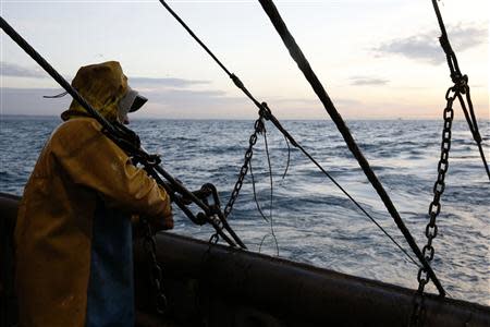 A fisherman on the Boulogne sur Mer based trawler "Nicolas Jeremy" prepares to raise fishing nets off the coast of northern France October 21, 2013. REUTERS/Pascal Rossignol