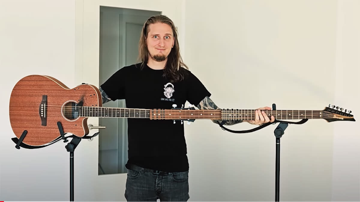  Bernth behind a three-neck-long acoustic guitar. 