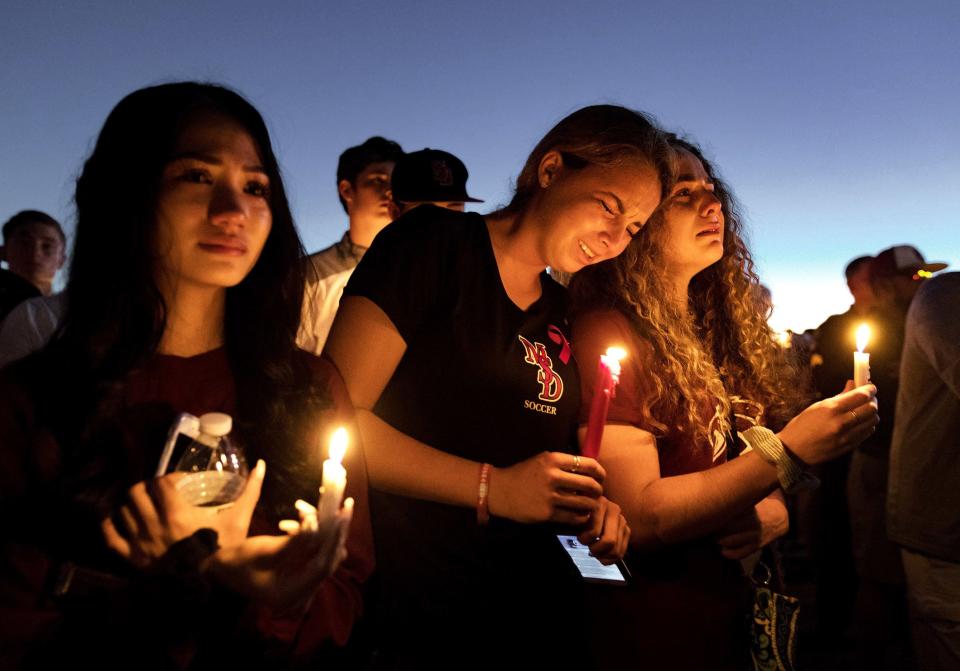 People attend a candlelit memorial service in February 2018 for the victims of the shooting at Marjory Stoneman Douglas High School in Parkland that killed 17 people.