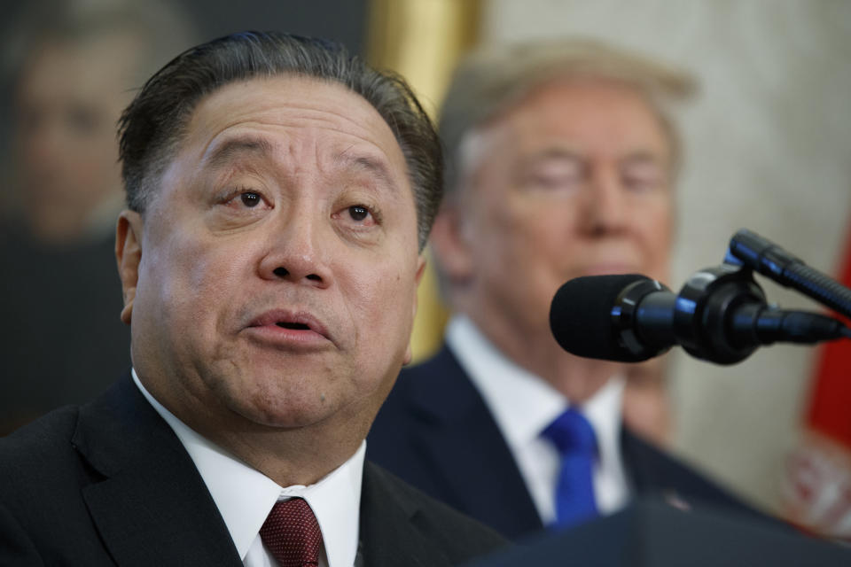 FILE - Broadcom CEO Hock Tan speaks as President Donald Trump listens during an event on Nov. 2, 2017 in Washington. Tan topped the AP survey of CEO pay with a package valued at about $162 million in 2023. (AP Photo/Evan Vucci, File)