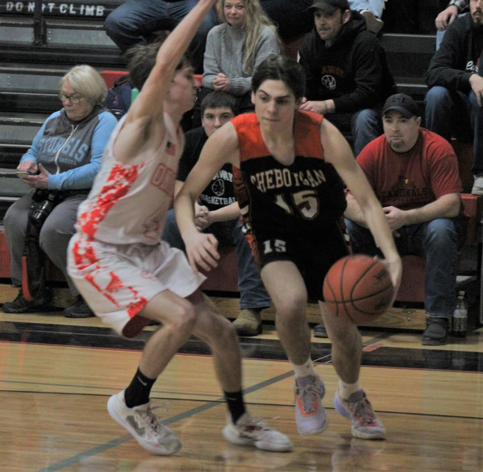 Cheboygan junior Patrick Watson (right) goes past Onaway junior Cole Selke during the second half of Friday night's game in Onaway.