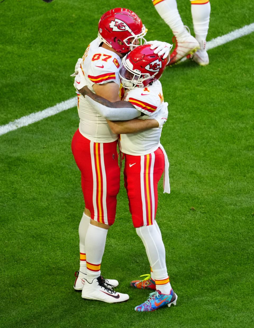 Kansas City Chiefs tight end Travis Kelce (87) hugs running back Jerick McKinnon (1) before playing the Philadelphia Eagles in Super Bowl LVII at State Farm Stadium in Glendale on Feb. 12, 2023.