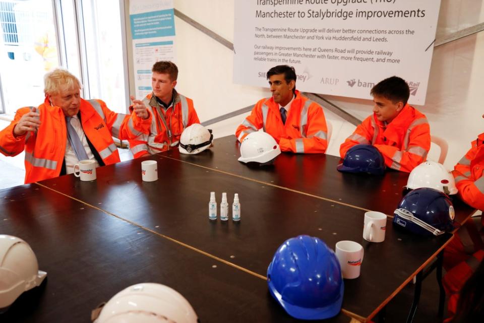 Prime Minister Boris Johnson and Chancellor Rishi Sunak speak with apprentices during a visit to a construction site in Manchester last October (Phil Noble/PA) (PA Wire)