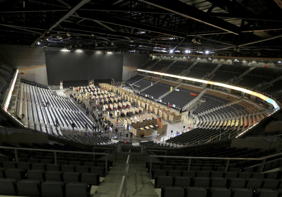 25 vaccination lanes with 30 registration counters are available to those wishing to be vaccinated in the Koenig-Pilsener-Arena in Oberhausen, Germany, Sunday, Dec. 19, 2021. Both first and second vaccinations as well as booster vaccinations are possible. The up to 5,000 visitors will receive either the vaccine from Biontech or from Moderna. (Roland Weihrauch/dpa via AP)