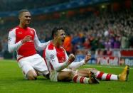 Arsenal's Alexis Sanchez celebrates with hs team mate Kieran Gibbs (L) after scoring a goal against Borussia Dortmund during their Champions League group D soccer match in London November 26, 2014. REUTERS/Eddie Keogh