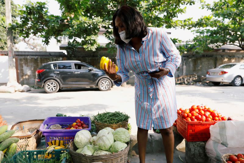 Melanie Igbe, head chef at Cafe de Elyon, shops for vegetables at a street market in Victoria Island, in Lagos