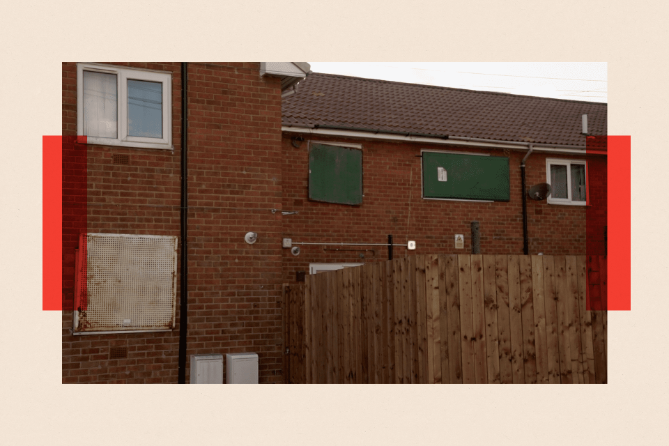 A row of homes with boarded up windows