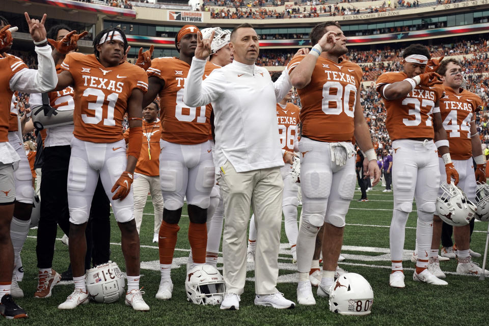 Texas head coach Steve Sarkisian, center, stands with his team as they sing "The Eyes Of Texas" after defeating Kansas State 22-17 in an NCAA college football game in Austin, Texas, Friday, Nov. 26, 2021. (AP Photo/Chuck Burton)