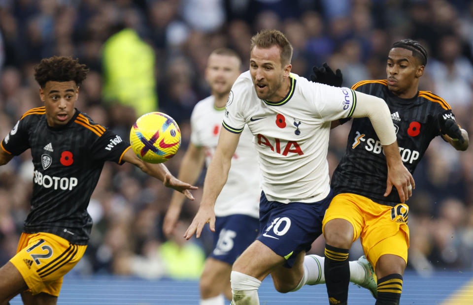 Tottenham's Harry Kane, center, duels for the ball with Leeds United's Crysencio Summerville during the English Premier League soccer match between Tottenham Hotspur and Leeds United at Tottenham Hotspur Stadium in London, Saturday, Nov. 12, 2022. (AP Photo/David Cliff)