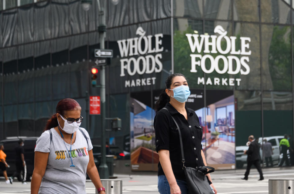 NEW YORK, NEW YORK - SEPTEMBER 01: People wear protective face masks outside of Whole Foods Market at the Hudson Yards as the city continues Phase 4 of re-opening following restrictions imposed to slow the spread of coronavirus on September 1, 2020 in New York City. The fourth phase allows outdoor arts and entertainment, sporting events without fans and media production. (Photo by Noam Galai/Getty Images)