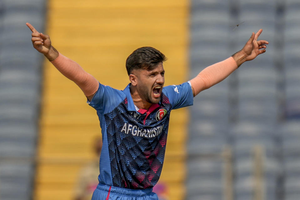 Afghanistan's Fazalhaq Farooqi appeals successfully against the for the wicket of Sri Lanka's Dimuth Karunaratne during the ICC Men's Cricket World Cup match between Sri Lanka and Afghanistan in Pune, India, Monday, Oct. 30, 2023. (AP Photo/Rajanish Kakade)