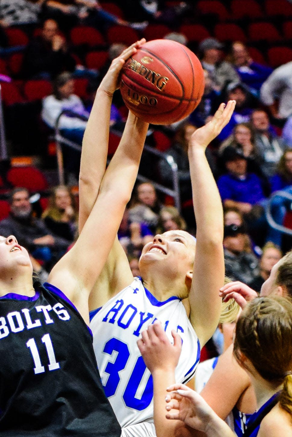 Colo-NESCO's Abigail Hostetler battles Baxter's Emie Tuhn for a rebound during the Royal girls' 57-21 loss to the unbeaten Bolts Jan. 11 at Wells Fargo Arena in Des Moines.