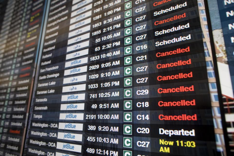 Board shows many flight cancellations and delays following a ‘bomb cyclone’ in Boston, Massachusetts.