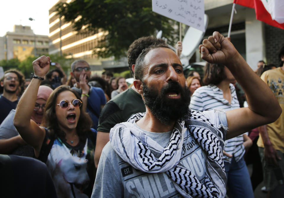 Anti-government protesters shout slogans, as they march during a protest against the central bank and the Lebanese government, in Beirut, Lebanon, Thursday, Oct. 31, 2019. Lebanese security forces were still struggling to open some roads Thursday as protesters continued their civil disobedience campaign in support of nationwide anti-government demonstrations. (AP Photo/Hussein Malla)