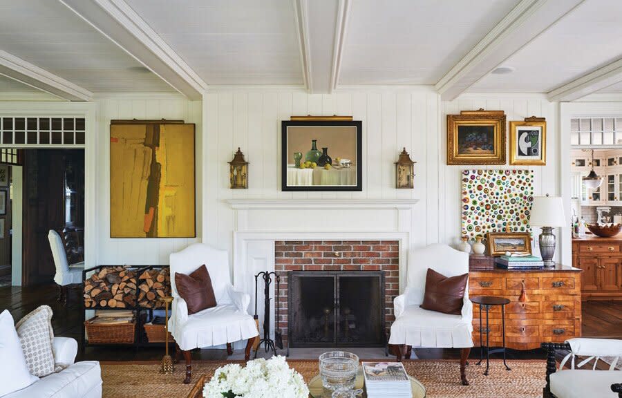 Historic Brick Fireplace with White Wood Paneling and Beamed Ceiling