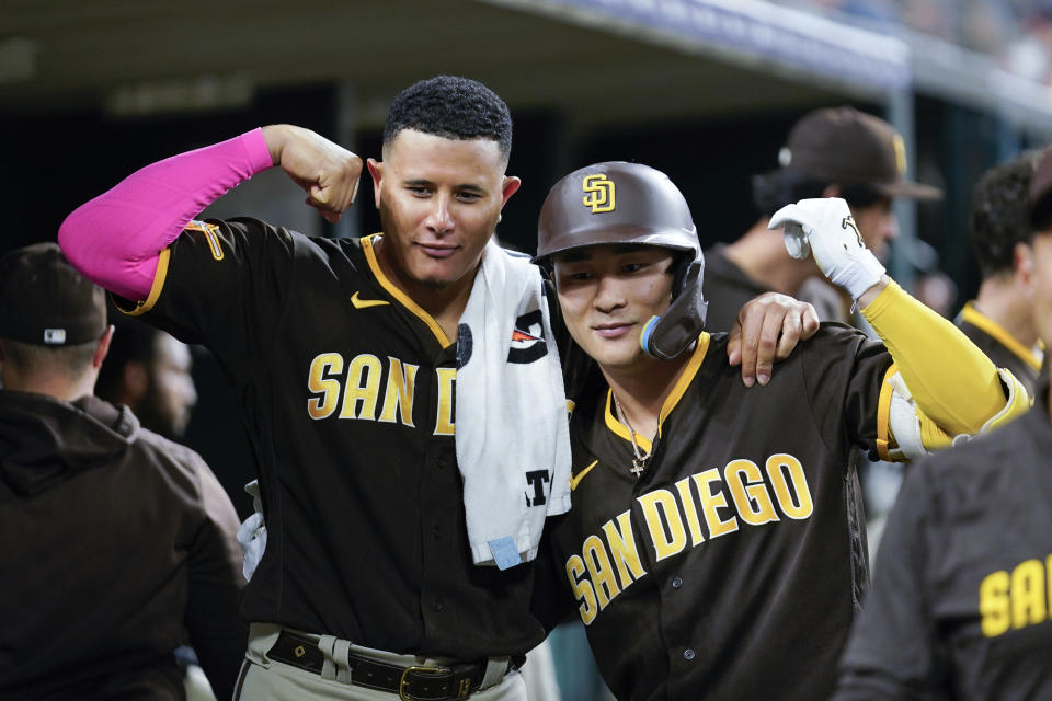 San Diego Padres' Ha-Seong Kim, right, celebrates his home run with Manny Machado, left, against the Detroit Tigers in the sixth inning of a baseball game, Saturday, July 22, 2023, in Detroit. (AP Photo/Paul Sancya)