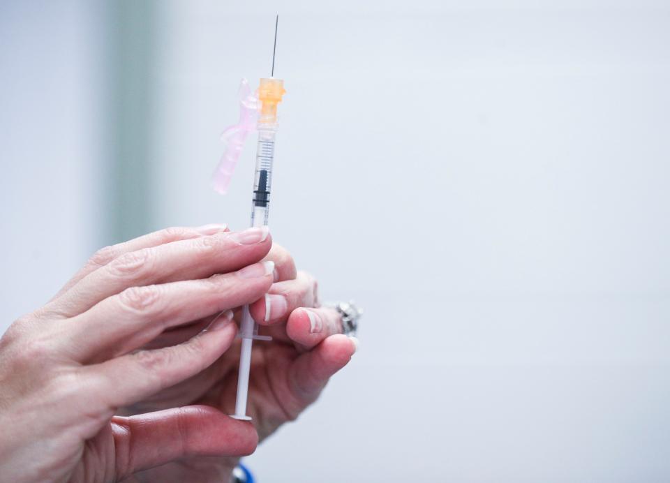 A nurse readies a syringe during a free vaccination event for students and faculty at Iroquois High School. The event was voluntary for those wishing to receive vaccinations for measles and Covid-19.  "We are bringing health care into our school buildings," said Angela Hayes, health services nurse practitioner for JCPS. "This is so crucial to keeping our students and staff safe."  Jan. 17, 2023 Jan. 17, 2023 