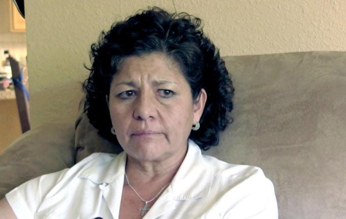 FILE - In this July 14, 2015, file photo from video, Tina Cordova talks of her late father, Anastacio Cordova, in her Albuquerque home. Cordova believes her father, who died in 2013 after suffering from multiple bouts of cancer, was affected by the atomic bomb Trinity Test in New Mexico since he lived in nearby Tularosa, N.M. as a child. Residents of the New Mexico Hispanic village near the site of the world&#39;s first atomic bomb test are planning another protest outside the annual opening of the site. The Tularosa Basin Downwinders Consortium say they will picket near the gates of the White Sands Missile Range April 6, 2019, as tourists travel to see the location of the Trinity Test. (AP Photo/Russell Contreras, File)