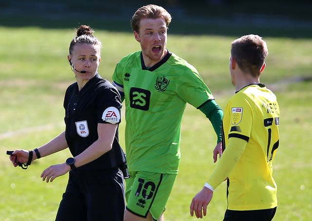 Referee Rebecca Welch (left) speaks with Port Vale’s Tom Conlon and Harrogate Town’s Lloyd Kerry (right) 