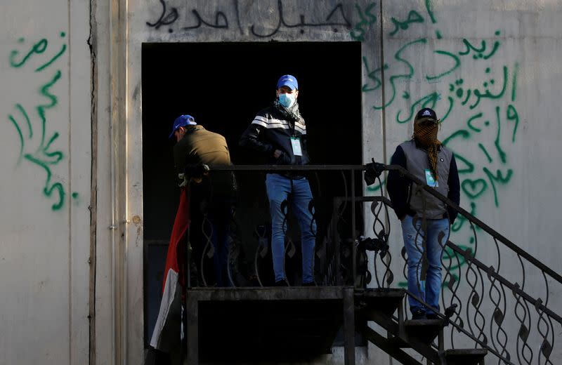 Supporters of Iraqi Shi'ite cleric Moqtada al-Sadr known as "blue hats" are seen at the high-rise building during ongoing anti-government protests in Baghdad