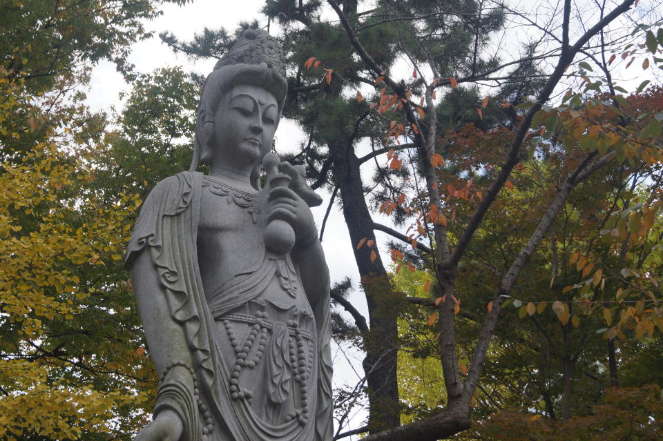 <p>A stone statue of Kannon, the Buddhist goddess of mercy, in Tokyo’s Shiba Park. (Photo: Michael Walsh/Yahoo News) </p>