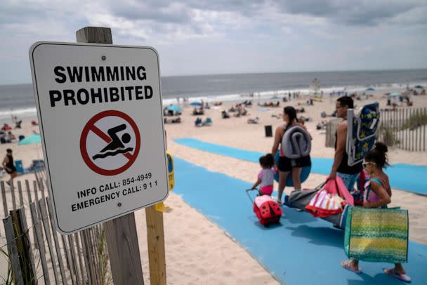 PHOTO: Beach-goers enjoy the surf at Smith Point County Park, a Long Island beach where a shark bit a lifeguard 10 days earlier, July 15, 2022, in Shirley, N.Y. Shark sightings were relatively rare in the region until recently. (John Minchillo/AP)