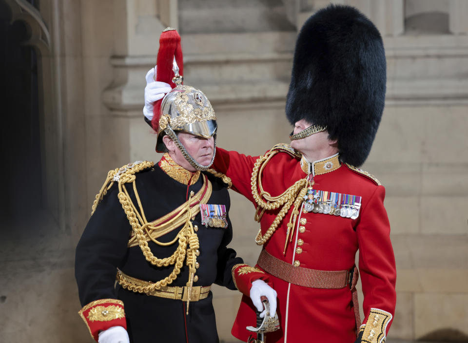 Members of the Household Cavalry prepare at the Sovereign's Entrance ahead of the State Opening of Parliament at Houses of Parliament, in London, Tuesday, May 10, 2022. Britain’s Parliament opens a new year-long session on Tuesday with a mix of royal pomp and raw politics, as Prime Minister Boris Johnson tries to re-energize his scandal-tarnished administration and revive the economy amid a worsening cost-of-living crisis. (Chris Jackson/Pool Photo via AP)