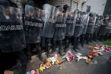 Policemen stand guard during a protest following the killing of a boy in Pereiaslav-Khmelnytskyi