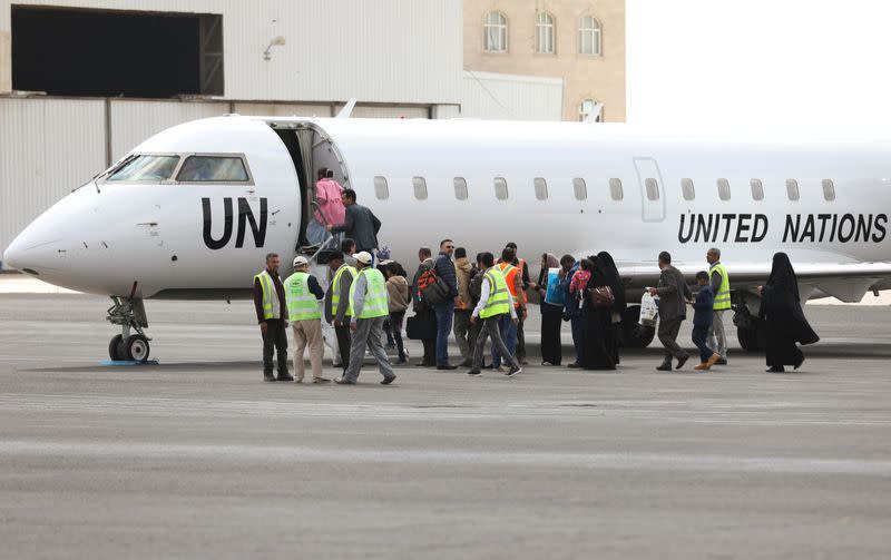 People board a United Nations plane which will carry them to Amman, Jordan in the first flight of a medical air bridge from Sanaa airport in Sanaa, Yemen