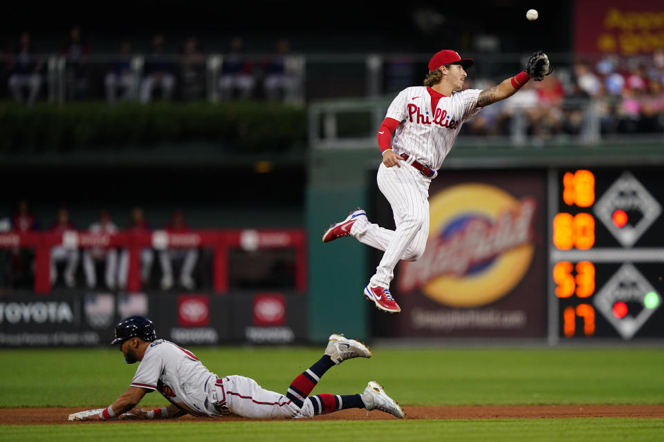 Atlanta Braves' Eddie Rosario, left, steals second past Philadelphia Phillies second baseman Bryson Stott during the fourth inning of a baseball game, Tuesday, July 26, 2022, in Philadelphia. (AP Photo/Matt Slocum)