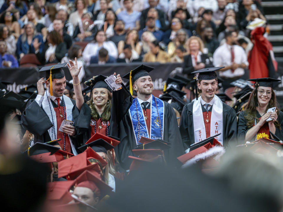 The Povolos quintuplets, from left; Marcus, Victoria, Ludovico, Michael, and Ashley stand during the commencement ceremony at the Montclair State University, Monday, May 13, 2024, in Montclair, N.J. (Mike Peters/Montclair State University via AP)