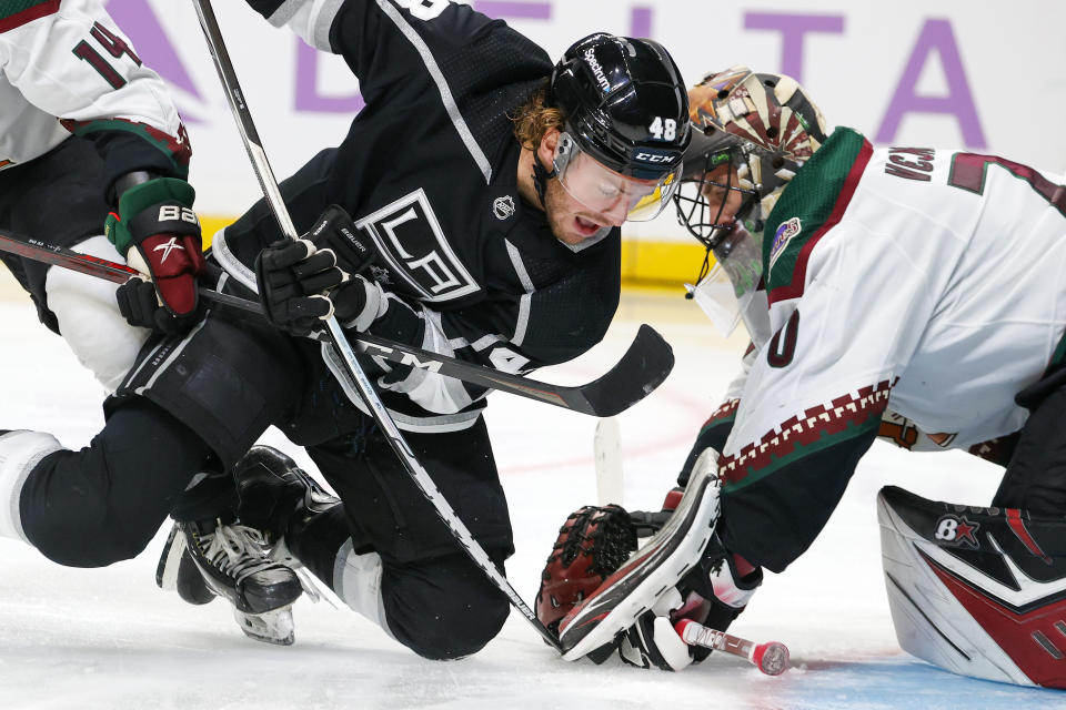 Arizona Coyotes goalie Karel Vejmelka, right, makes a save against Los Angeles Kings forward Brendan Lemieux during the second period of an NHL hockey game Sunday, Nov. 21, 2021, in Los Angeles. (AP Photo/Ringo H.W. Chiu)