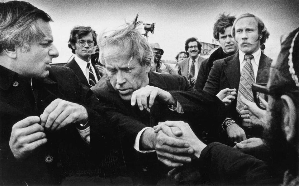 At Madison's airport, a demonstrator spits in the face of Washington Sen. Henry "Scoop" Jackson during Jackson's campaign stop during the Wisconsin Primary on March 30, 1976. Jackson had been known as a "hawk" on the Vietnam War. Madison, the home of the University of Wisconsin, was noted for its antiwar protests.