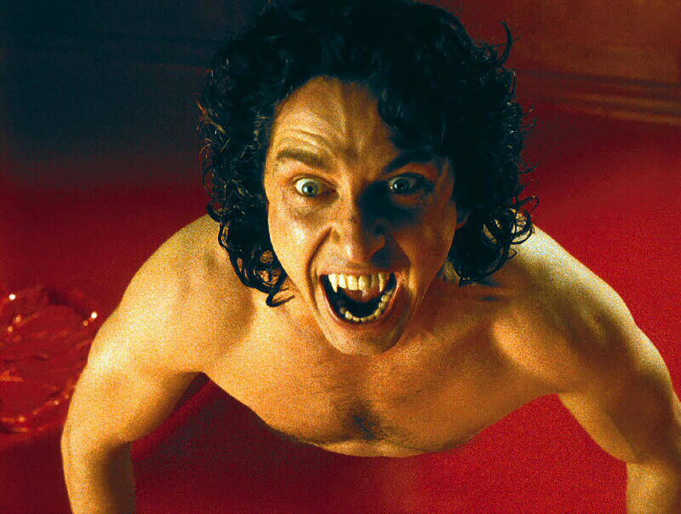 A naked vampire bares his fangs in a pool of blood