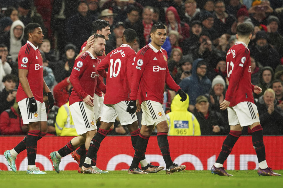 Manchester United's Luke Shaw, second from left, celebrates with teammates after scoring his side's second goal during the English Premier League soccer match between Manchester United and Bournemouth at Old Trafford in Manchester, England, Tuesday, Jan. 3, 2023. (AP Photo/Dave Thompson)