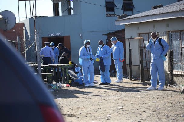 PHOTO: Forensic personnel investigate after the deaths of patrons found inside the Enyobeni Tavern, in Scenery Park, outside East London in the Eastern Cape province, South Africa, June 26, 2022. (Reuters, FILE)