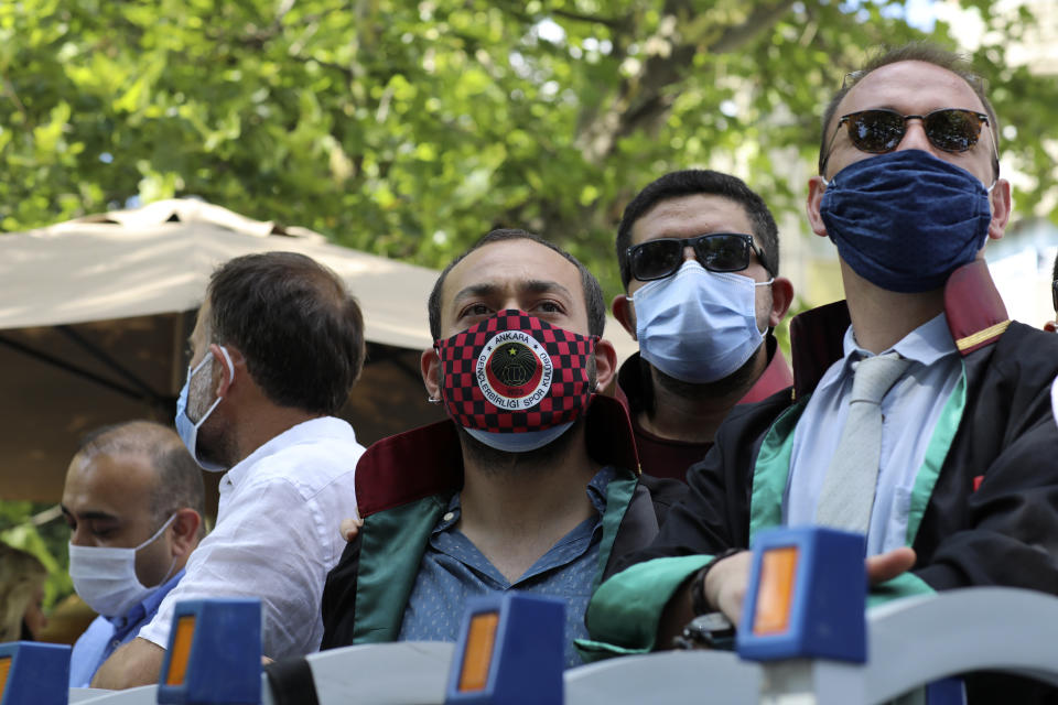 Lawyers wait to enter a public garden for a protest against the government, in Ankara, Turkey, Thursday, July 9, 2020. Turkey's Bar Associations continue to protest against the government's plans to amend laws regulating on lawyers and their associations. (AP Photo/Burhan Ozbilici)