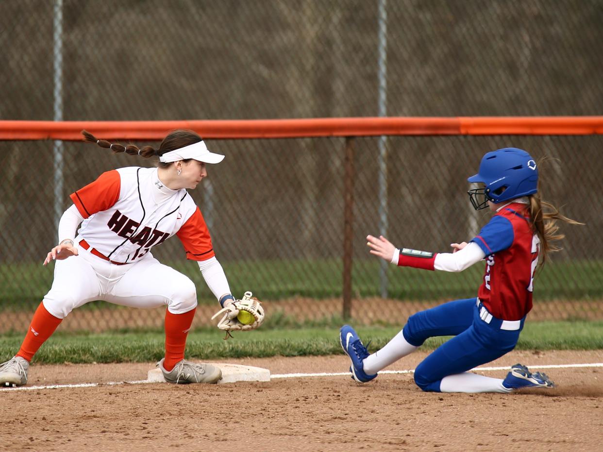 Heath's Kyndall Spicer tags out Licking Valley's Ellie Facemire at third base during the visiting Panthers' 4-0 victory on Thursday, March 28, 2024.