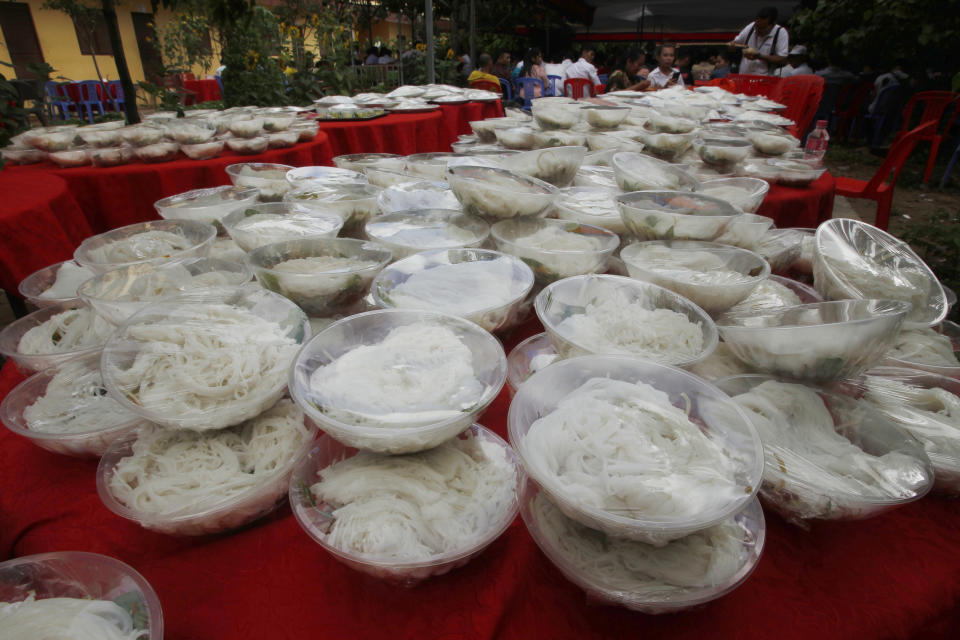 Bowls of noodle are placed at a Buddhist pagoda for garment workers at outside Phnom Penh, Cambodia, Sunday, June 9, 2019. The bitter decadeslong rivalry between Hun Sen, Cambodia's strongman leader, and Sam Rainsy, the self-exiled chief political rival and critic, has sometimes played out in deadly violence. But on Sunday, soup rather than blood was likely to be spilled. (AP Photo/Heng Sinith)